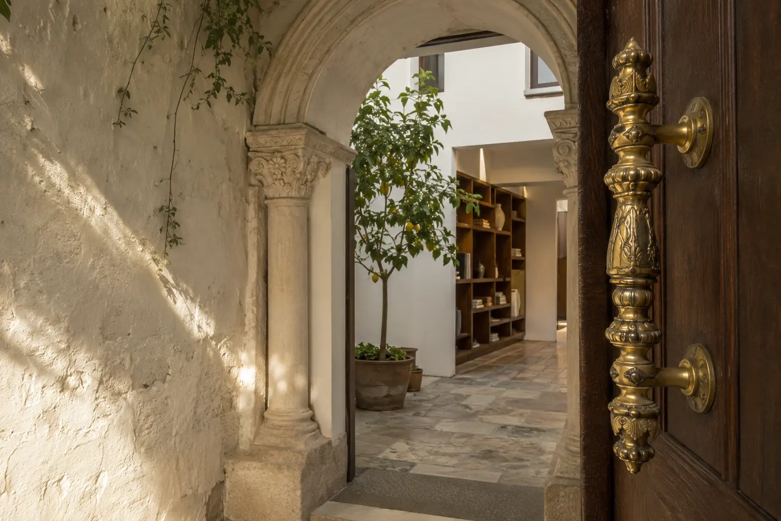 Casa Adarve — umbral con arco de piedra barroco en callejón del barrio de Santa Cruz, Sevilla